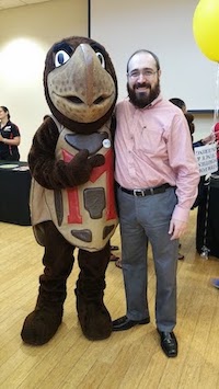 man standing next to Terp mascot