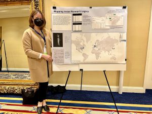 Jessica Grimmer standing in front of a presentation board displaying her work from the Library of Congress