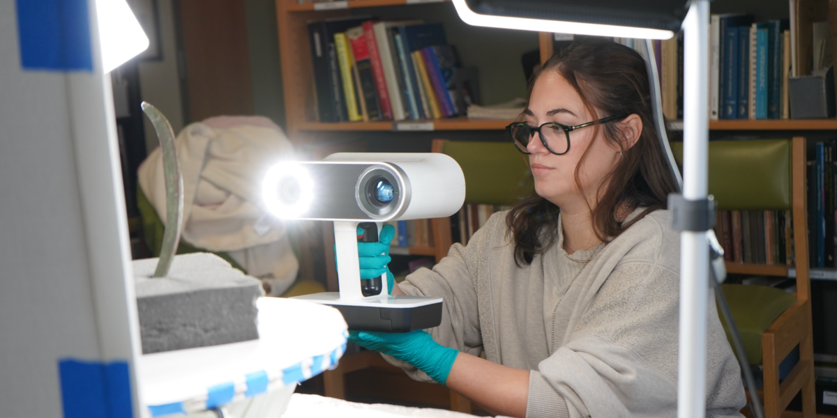 Researcher scanning artifacts