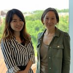 two women standing next to each other smiling