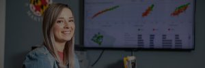 Image student sitting in front of white board with data analytics