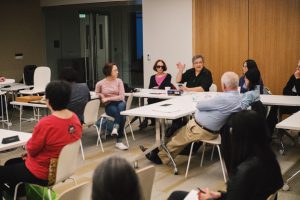 people sitting around a room talking